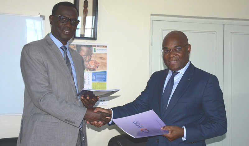 L-R: NBI ED Eng. Innocent Ntabana (L) shakes hands with AFD's Yako after the grant agreement signing
