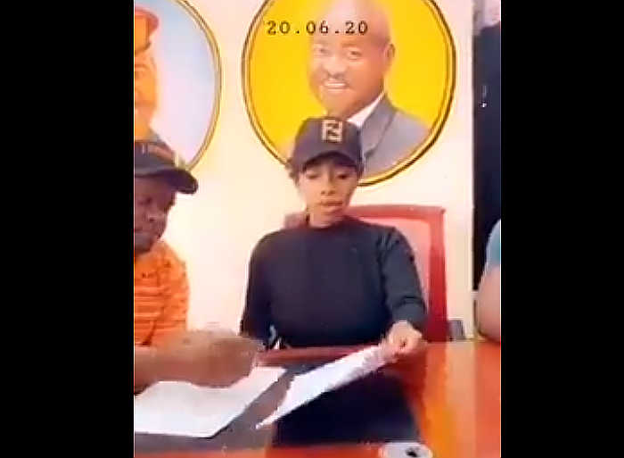 Bad Black signing papers in Balaam's office