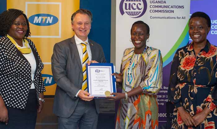 MTN CEO Wim Vanhellpute shakes hands with UCC Acting ED Irene Kaggwa Sewankambo after the signing of the License extension at UCC Headquarters in Bugoloobi on July 10, 2020